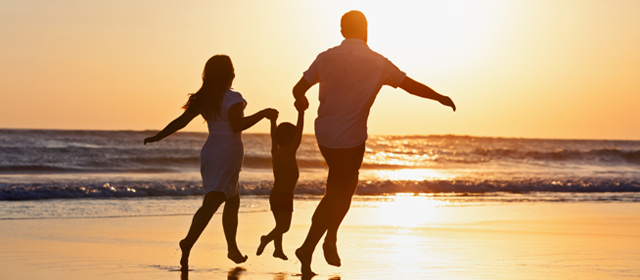 Family Running on the Beach at Sunset